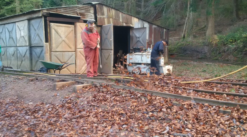 Richard using compressed air to blow leaves from the track